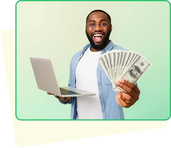 A man holding dollars and a laptop smiling with a green background